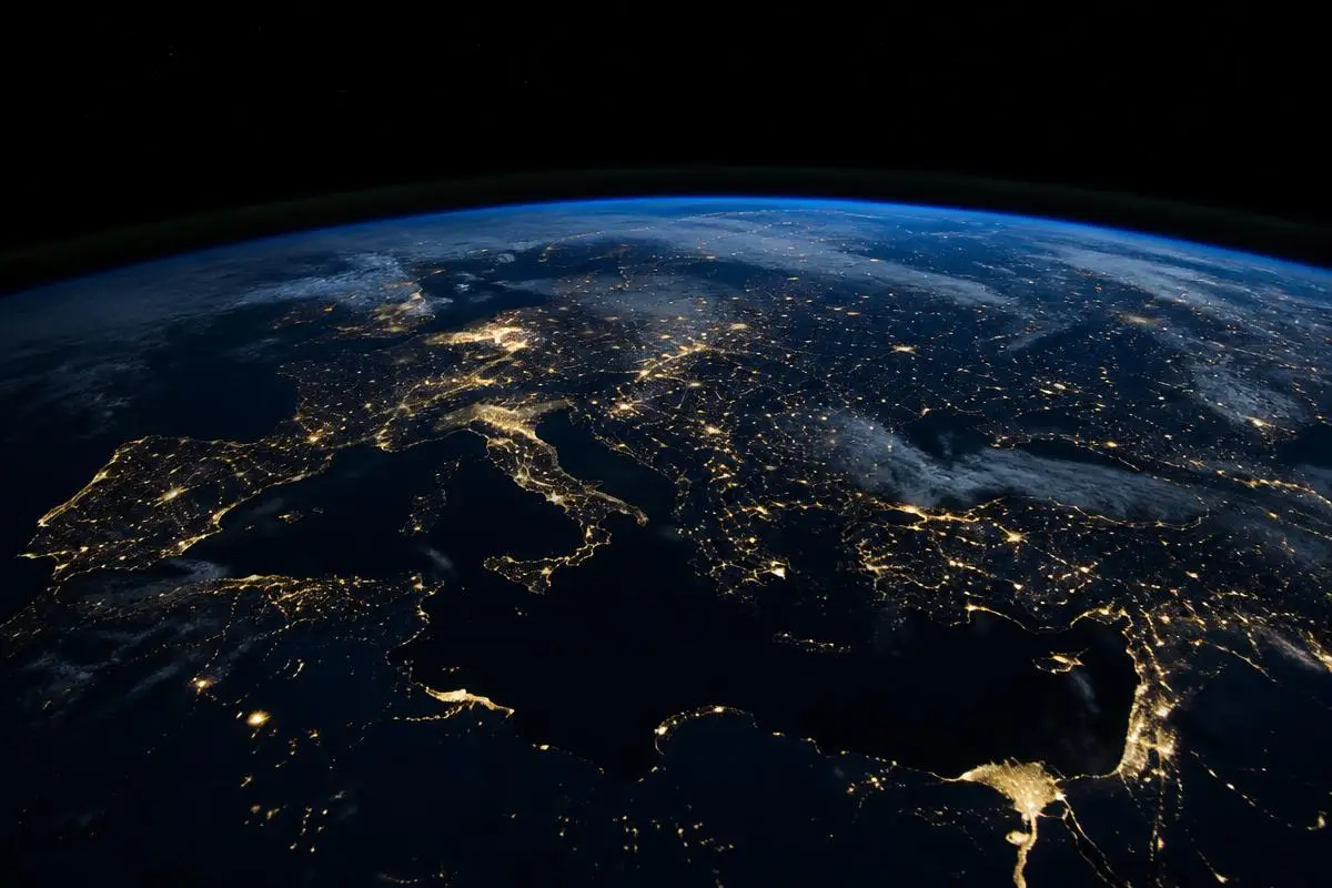 Earth at night from orbit illustrating the cross-border jurisdictional reach and limits of cryptocurrency exchange cooperation
